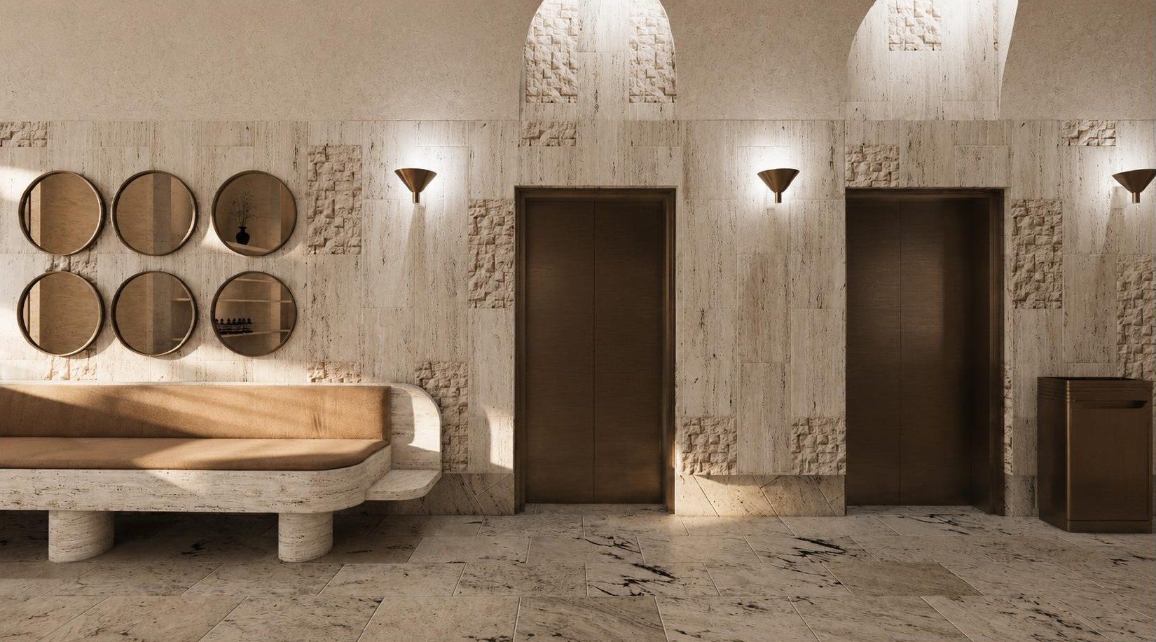 The entry wall in split face stone with round bronze mirrors